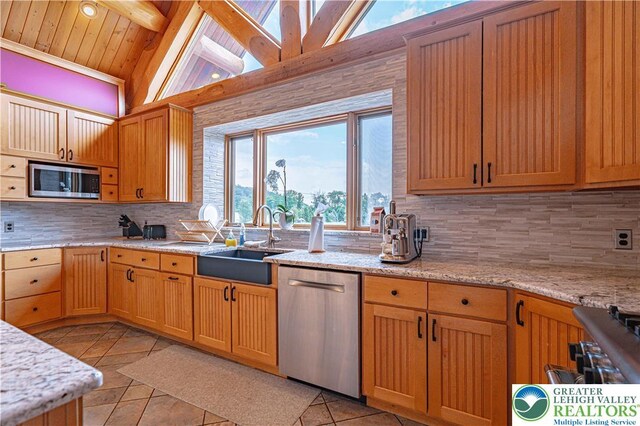 379 Meyer Rd, Bushkill Twp, PA 18064 - kitchen featuring appliances with stainless steel finishes, light tile patterned floors, tasteful backsplash, light stone countertops, and wood ceiling