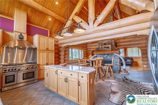 379 Meyer Rd, Bushkill Twp, PA 18064 - kitchen featuring appliances with stainless steel finishes, rustic walls, high vaulted ceiling, a wood ceiling with exposed beams, and wall chimney range hood
