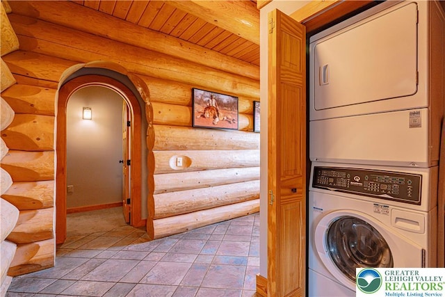 379 Meyer Rd, Bushkill Twp, PA 18064 - laundry area with log walls, stacked washer / drying machine, wood ceiling, and arched walkways
