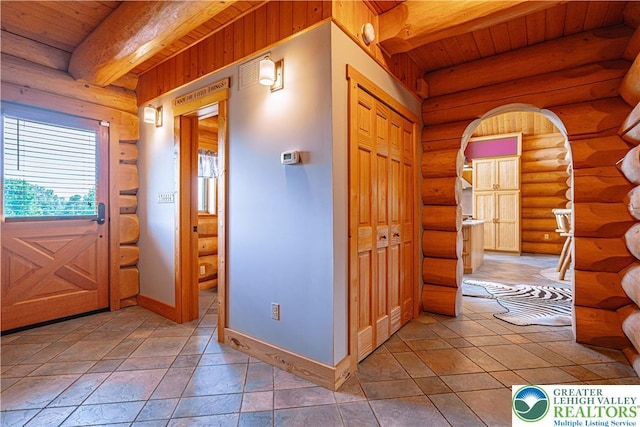 379 Meyer Rd, Bushkill Twp, PA 18064 - foyer with rustic walls and a wood ceiling with exposed beams