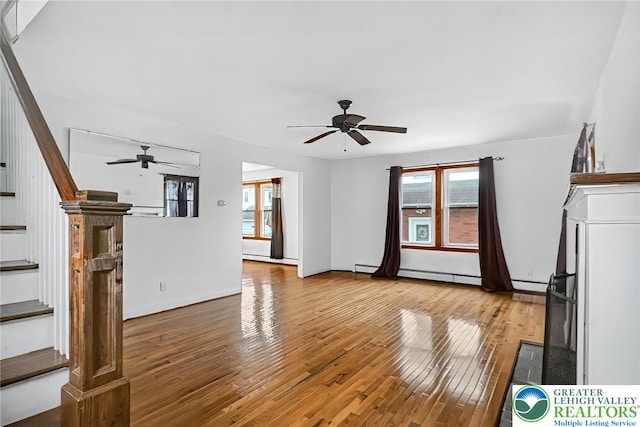 815 Summit Ave, Prospect Park, PA 19076 - unfurnished living room with a ceiling fan, hardwood / wood-style floors, baseboard heating, and stairs