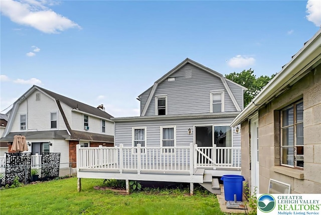 815 Summit Ave, Prospect Park, PA 19076 - rear view of house with a gambrel roof, a deck, and a lawn