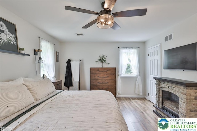 1925 Peach Tree Ln, Lower Saucon Twp, PA 18015 - bedroom with wood finished floors, a stone fireplace, and a ceiling fan