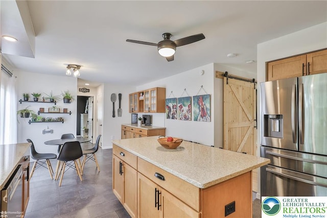 1925 Peach Tree Ln, Lower Saucon Twp, PA 18015 - kitchen featuring stainless steel fridge with ice dispenser, a barn door, ceiling fan, a kitchen island, and light stone countertops