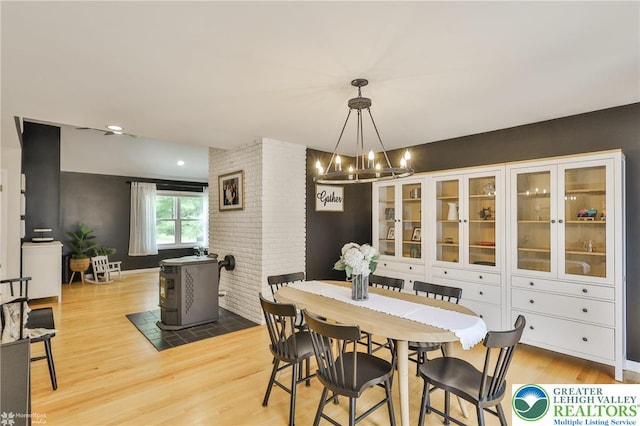 1925 Peach Tree Ln, Lower Saucon Twp, PA 18015 - dining space featuring a chandelier, light wood-style flooring, and a wood stove