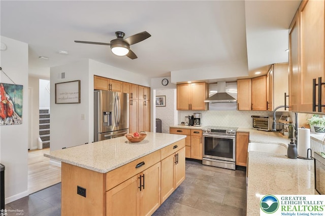 1925 Peach Tree Ln, Lower Saucon Twp, PA 18015 - kitchen with stainless steel appliances, wall chimney range hood, a ceiling fan, backsplash, and light stone counters