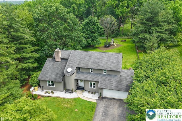 1925 Peach Tree Ln, Lower Saucon Twp, PA 18015 - view of front of property featuring roof with shingles, a chimney, a front yard, driveway, and a forest view