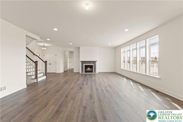 1901 Meadows Rd, Lower Saucon Twp, PA 18015 - unfurnished living room with wood finished floors, recessed lighting, stairs, and a lit fireplace