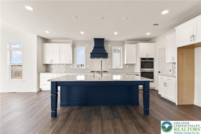 1901 Meadows Rd, Lower Saucon Twp, PA 18015 - kitchen with custom range hood, appliances with stainless steel finishes, a breakfast bar area, backsplash, and recessed lighting