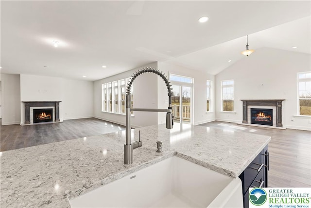 1901 Meadows Rd, Lower Saucon Twp, PA 18015 - kitchen featuring a warm lit fireplace, open floor plan, plenty of natural light, vaulted ceiling, and recessed lighting