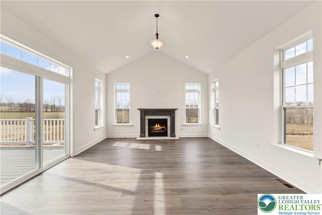 1901 Meadows Rd, Lower Saucon Twp, PA 18015 - unfurnished living room featuring wood finished floors, lofted ceiling, and a lit fireplace