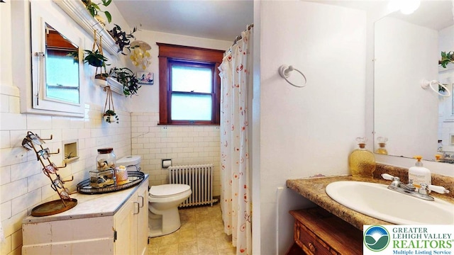 1446 Chew St, Allentown City, PA 18104 - bathroom with radiator heating unit, vanity, tile patterned floors, a shower with shower curtain, and tile walls