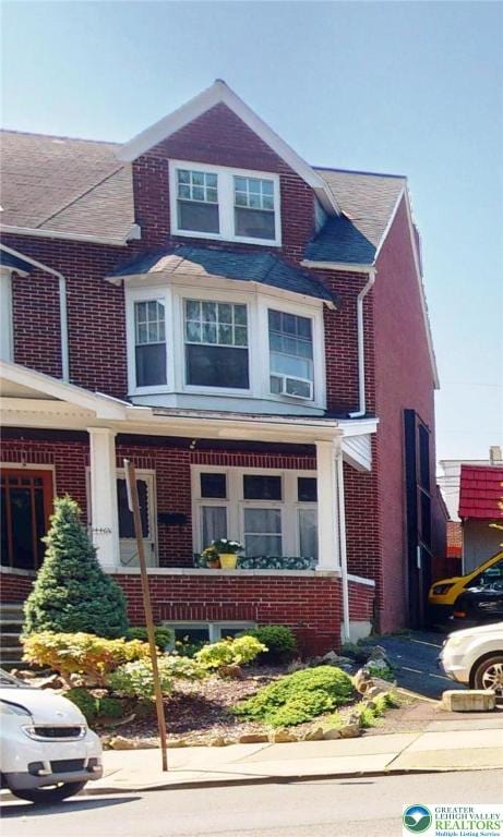 1446 Chew St, Allentown City, PA 18104 - view of front of home featuring brick siding, a porch, and a shingled roof