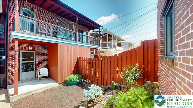 1446 Chew St, Allentown City, PA 18104 - view of side of property with brick siding and a balcony