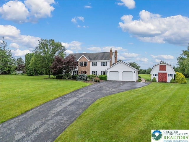 1151 Marfield Dr, Bushkill Twp, PA 18064 - colonial inspired home featuring a barn, an outbuilding, a front yard, a garage, and driveway