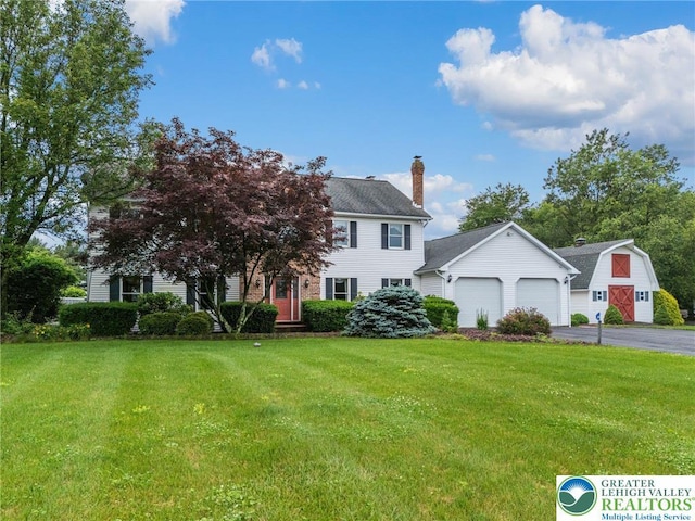 1151 Marfield Dr, Bushkill Twp, PA 18064 - view of front facade with a front lawn, driveway, a chimney, and an attached garage