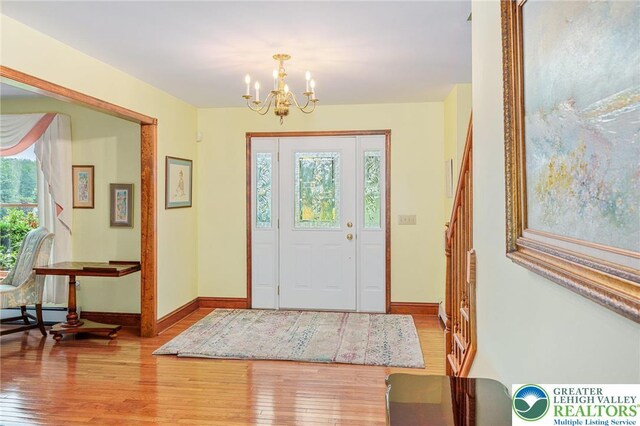 1151 Marfield Dr, Bushkill Twp, PA 18064 - entryway with hardwood / wood-style floors, a chandelier, and healthy amount of natural light