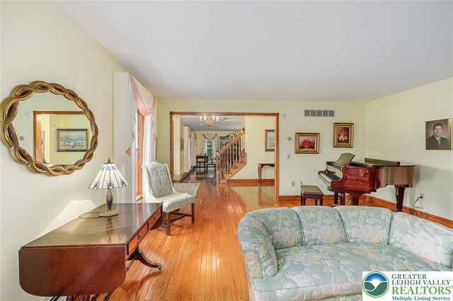 1151 Marfield Dr, Bushkill Twp, PA 18064 - living area featuring a chandelier, stairs, and light wood finished floors
