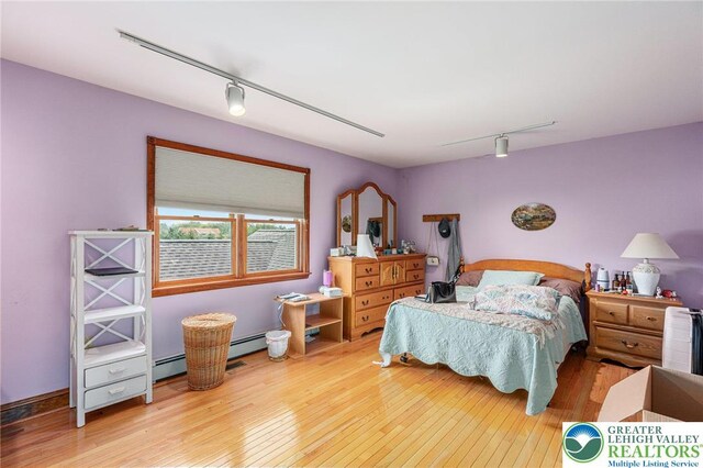1151 Marfield Dr, Bushkill Twp, PA 18064 - bedroom featuring track lighting, hardwood / wood-style flooring, and a baseboard radiator