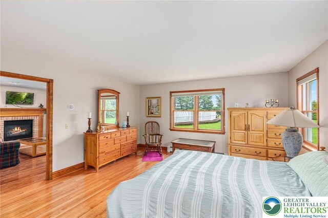 1151 Marfield Dr, Bushkill Twp, PA 18064 - bedroom with light wood-style flooring and a brick fireplace