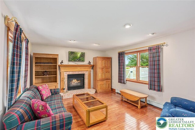 1151 Marfield Dr, Bushkill Twp, PA 18064 - living area featuring hardwood / wood-style flooring, a brick fireplace, and recessed lighting