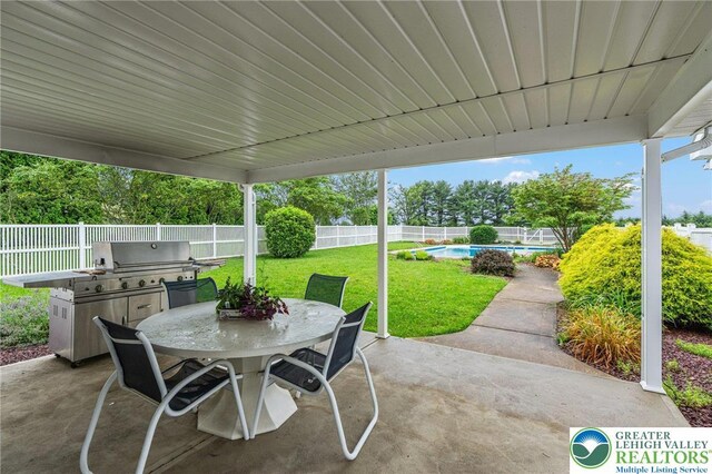 1151 Marfield Dr, Bushkill Twp, PA 18064 - fenced backyard featuring outdoor dining space, a patio, and area for grilling