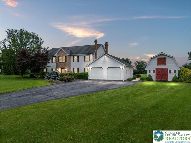 1151 Marfield Dr, Bushkill Twp, PA 18064 - colonial house featuring a barn, a front lawn, an outbuilding, a detached garage, and a chimney