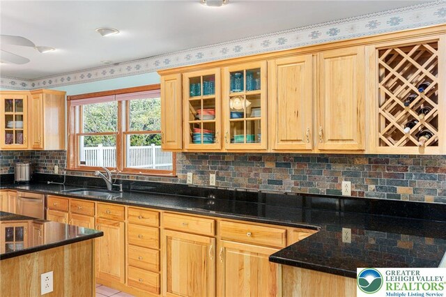1151 Marfield Dr, Bushkill Twp, PA 18064 - kitchen featuring light brown cabinetry, stainless steel dishwasher, tasteful backsplash, a ceiling fan, and dark stone counters