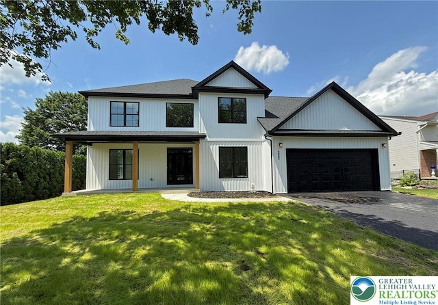 3631 Oak Ridge Dr, Washington Twp, PA 18080 - modern inspired farmhouse featuring driveway, an attached garage, a front lawn, and roof with shingles