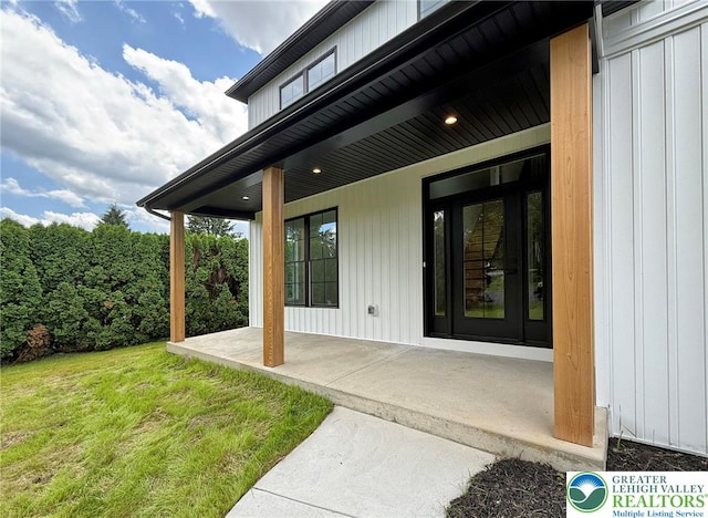 3631 Oak Ridge Dr, Washington Twp, PA 18080 - view of exterior entry featuring board and batten siding and a yard