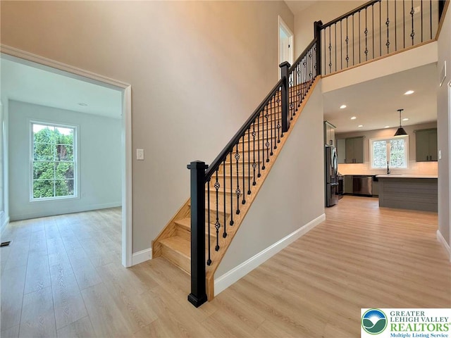 3631 Oak Ridge Dr, Washington Twp, PA 18080 - stairway featuring wood finished floors, a towering ceiling, and recessed lighting