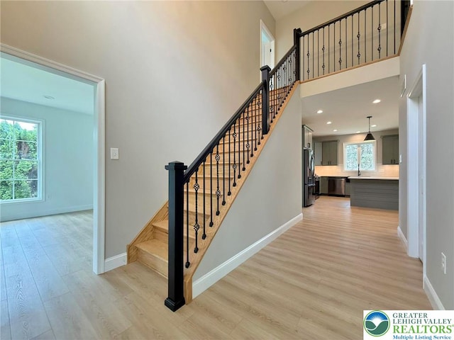 3631 Oak Ridge Dr, Washington Twp, PA 18080 - stairs featuring wood finished floors, a towering ceiling, and recessed lighting