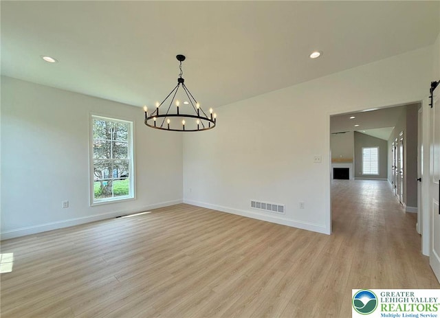 3631 Oak Ridge Dr, Washington Twp, PA 18080 - unfurnished room with light wood-style floors, a chandelier, recessed lighting, and a barn door