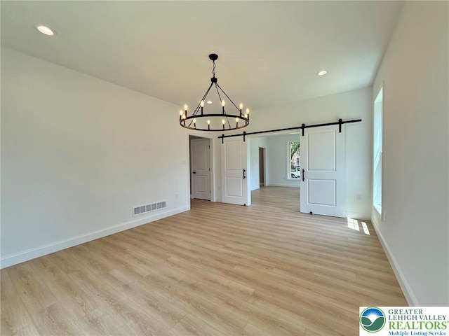 3631 Oak Ridge Dr, Washington Twp, PA 18080 - unfurnished dining area featuring a barn door, a chandelier, light wood-style flooring, and recessed lighting