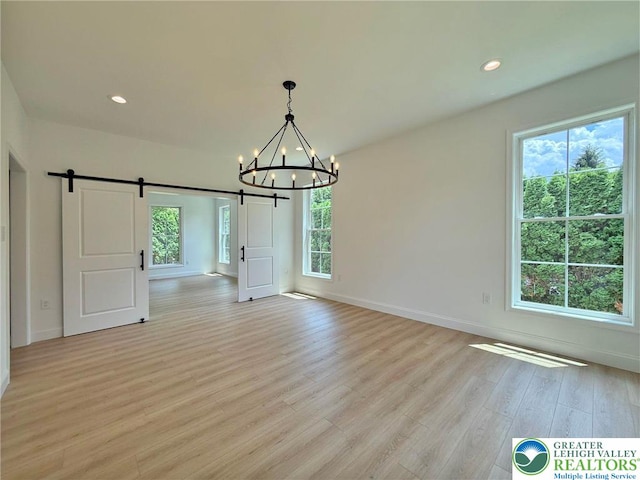3631 Oak Ridge Dr, Washington Twp, PA 18080 - unfurnished dining area with a barn door, a chandelier, light wood-style flooring, and recessed lighting