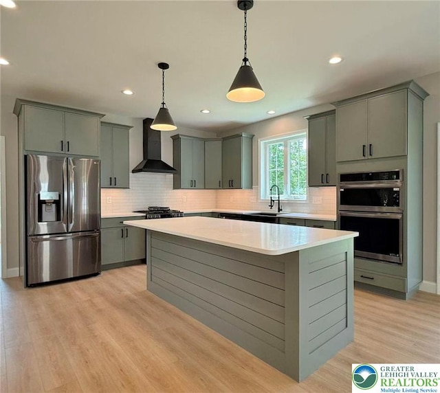 3631 Oak Ridge Dr, Washington Twp, PA 18080 - kitchen with stainless steel appliances, wall chimney exhaust hood, gray cabinetry, light countertops, and a kitchen island