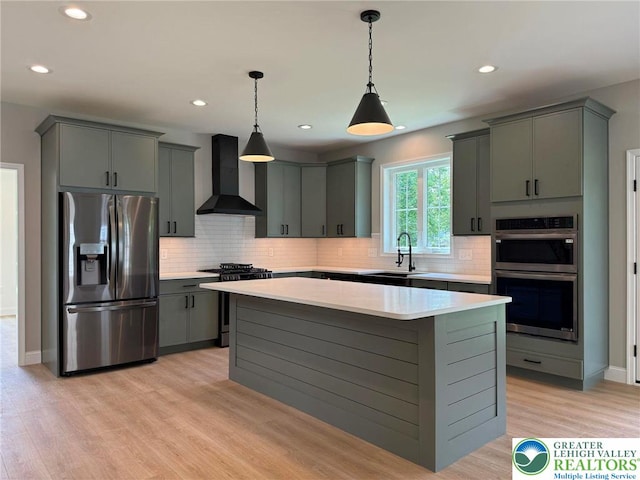 3631 Oak Ridge Dr, Washington Twp, PA 18080 - kitchen with appliances with stainless steel finishes, wall chimney range hood, light countertops, gray cabinetry, and backsplash