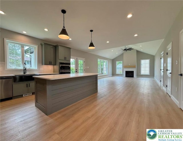 3631 Oak Ridge Dr, Washington Twp, PA 18080 - kitchen featuring stainless steel appliances, gray cabinets, a center island, light wood finished floors, and light countertops