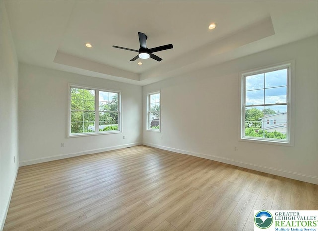 3631 Oak Ridge Dr, Washington Twp, PA 18080 - spare room featuring a tray ceiling, light wood-style flooring, ceiling fan, and recessed lighting