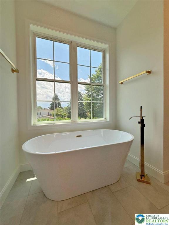 3631 Oak Ridge Dr, Washington Twp, PA 18080 - bathroom featuring a freestanding bath and tile patterned floors