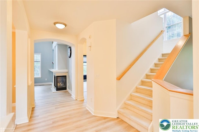780 Ramblewood Dr, Forks Twp, PA 18040 - hall featuring plenty of natural light, wood finished floors, arched walkways, and stairs