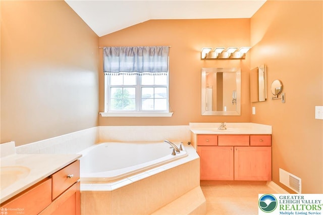 780 Ramblewood Dr, Forks Twp, PA 18040 - bathroom with two vanities, lofted ceiling, a bath, and tile patterned flooring