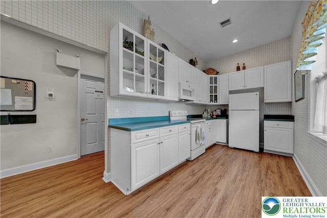 4693 Bluegrass Ln, Lower Macungie Twp, PA 18062 - kitchen featuring white appliances, light wood finished floors, glass insert cabinets, white cabinets, and recessed lighting