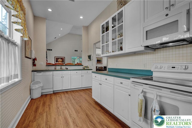 4693 Bluegrass Ln, Lower Macungie Twp, PA 18062 - kitchen with white appliances, vaulted ceiling, light wood-style floors, glass insert cabinets, and healthy amount of natural light