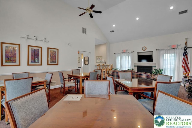 4693 Bluegrass Ln, Lower Macungie Twp, PA 18062 - dining room with high vaulted ceiling, ceiling fan, plenty of natural light, a tiled fireplace, and recessed lighting