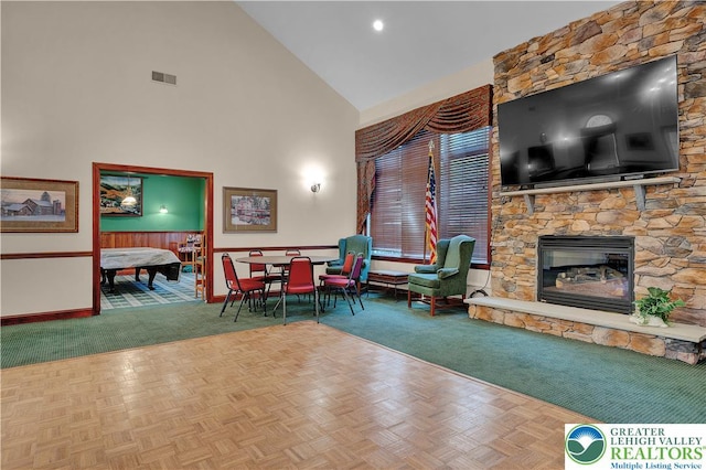 4693 Bluegrass Ln, Lower Macungie Twp, PA 18062 - carpeted living area with high vaulted ceiling and a stone fireplace