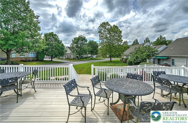 4693 Bluegrass Ln, Lower Macungie Twp, PA 18062 - wooden terrace with outdoor dining space, a residential view, and a lawn