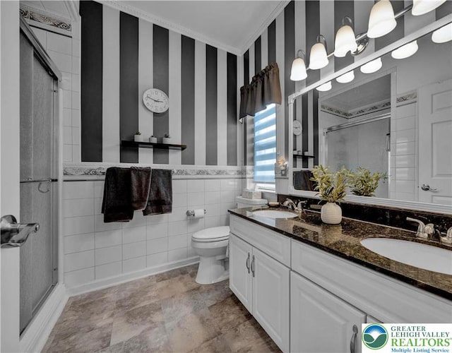 4693 Bluegrass Ln, Lower Macungie Twp, PA 18062 - bathroom with wallpapered walls, a shower stall, double vanity, ornamental molding, and tile walls