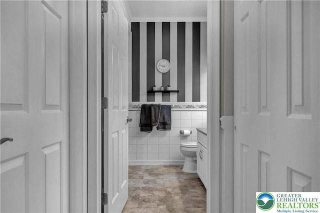 4693 Bluegrass Ln, Lower Macungie Twp, PA 18062 - bathroom with tile walls, wainscoting, and wallpapered walls