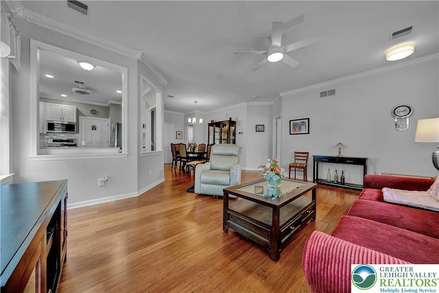 4693 Bluegrass Ln, Lower Macungie Twp, PA 18062 - living area with a ceiling fan, light wood-style floors, a chandelier, and crown molding